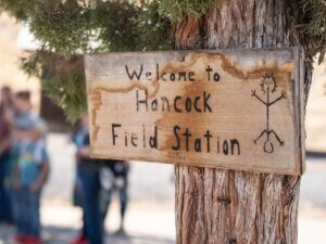 Sign reading Welcome to Hancock Field Station nailed on a tree