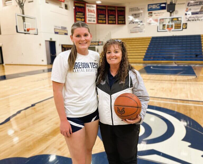 OIT's women's basketball coach poses with one of the players.