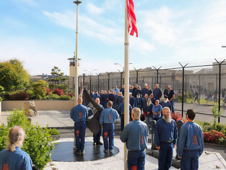 Incarcerated veterans raise the POW-MIA flag at OSP.