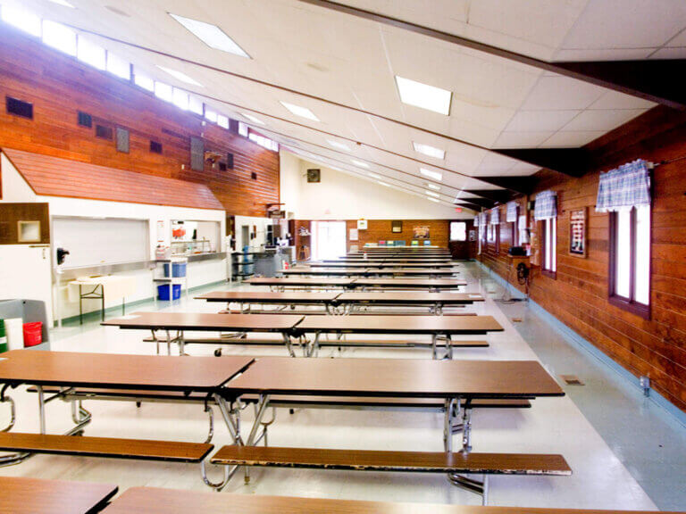 Empty cafeteria tables ready for the next camp meal