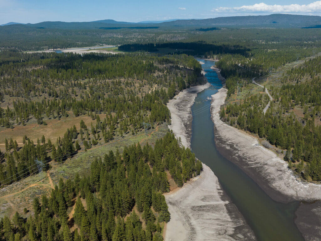 An overhead view of the Klamath River between newly exposed riverbanks