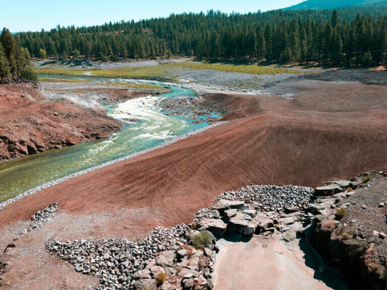 A bare earth riverbank ready for replanting